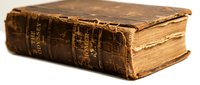 Antique leather-bound book with worn brown cover and aged pages, suitable for historical, literary, educational, and vintage design projects.