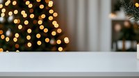 Festive white table surface with blurred Christmas tree lights bokeh background creating magical holiday atmosphere for product display or mockup.