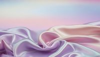 Luxurious silk fabric with soft pastel gradient colors flowing in elegant waves, creating dreamy textile background for fashion and design projects.