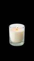Lit scented candle in clear glass container, isolated on transparent background. Ready for design use on product packaging, home decor graphics, e-commerce, stickers, and print-on-demand merchandise.