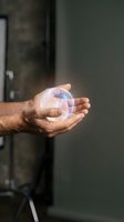 Male hands holding glowing transparent sphere with rainbow reflections in modern interior space for technology and innovation concepts.