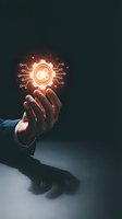 Hand holding glowing artificial intelligence circuit board icon with orange light against dark background. Concept for technology innovation and digital transformation.