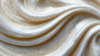 Elegant flowing waves of cream and gold marble texture create luxurious abstract background for high-end design projects.