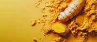 Fresh turmeric root and powder scattered on yellow background, close up view showing natural organic spice texture and vibrant golden color.