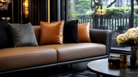 Modern brown leather sofa with black and tan decorative pillows in luxurious living room setting near window, elegant interior design with ambient lighting.