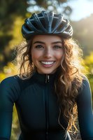 Happy young Caucasian woman cyclist wearing safety helmet and athletic jacket smiling outdoors in golden sunlight for active lifestyle and fitness.