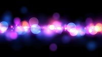 Glowing blue and purple bokeh lights on black background create dreamy atmospheric effect, soft defocused circles form magical light trail pattern.