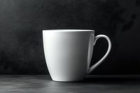 White ceramic coffee mug on dark background with dramatic side lighting creating soft shadows and highlights, minimalist composition for commercial and editorial use.
