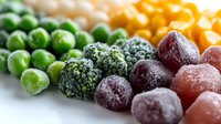 Frozen mixed vegetables and fruits arranged in rows showing peas, broccoli, cherries and corn kernels with frost crystals on surface, macro food photography.