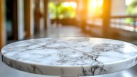 Elegant round marble table surface with natural veining pattern captured in soft window light, creating luxurious atmosphere for interior design and product display.