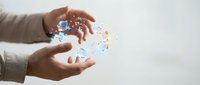 Hands protecting holographic Earth globe with network connections representing global communication, environmental protection, and digital technology innovation.