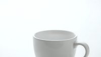 White ceramic coffee mug isolated on clean background for product mockups and branding designs.