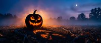 Spooky Halloween jack-o-lantern pumpkin glowing in misty field at twilight with crescent moon. Perfect for autumn seasonal decorations and horror themes.