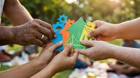 Multiple hands holding colorful paper cutout figures together outdoors, representing teamwork, unity, community support, and collaborative partnership for nonprofit or charity campaigns.