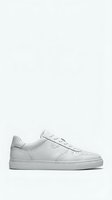 White leather sneaker isolated on light background for fashion and footwear design projects.