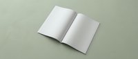 Open blank white magazine or brochure mockup on sage green background for branding and marketing design projects.