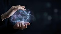 Young adult with pale skin holding glowing electric energy between hands against dark background. Suitable for technology, innovation, power, and science concepts.