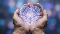 Hands holding glowing geometric heart with network connections on blurred blue background. Digital love, technology care, healthcare innovation concept.