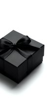 Elegant black gift box with satin ribbon bow isolated on white background, for luxury holiday, birthday, or corporate gifting concepts.
