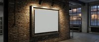 Modern industrial loft interior with blank white frame on exposed brick wall, perfect for mockup presentations and contemporary design projects.