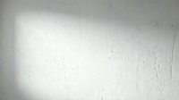 White textured wall surface with subtle scratches and imperfections for modern interior design backgrounds and architectural projects.