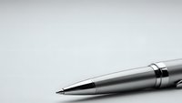 Silver metallic ballpoint pen with chrome accents on clean white background for business and office design projects.