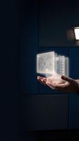 Hand holding glowing holographic server and circuit board icons against dark blue background, representing cloud computing, data storage, and digital technology solutions for business applications.
