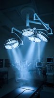 Modern surgical lights illuminating operating room table with bright LED technology for medical procedures and hospital surgery environments.