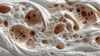 Abstract organic foam texture with flowing bubbles and creamy beige tones creates natural sculptural patterns for modern design backgrounds.
