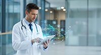 Male doctor using digital tablet with holographic medical data visualization in modern hospital corridor for healthcare technology innovation.