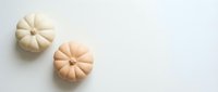 Two decorative mini pumpkins in cream and peach colors on white background for autumn seasonal design, fall crafts and holiday decorations.