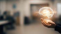 Businessman hand holding glowing brain hologram with digital network connections in modern office environment for artificial intelligence concepts.