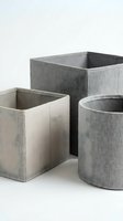 Gray fabric storage baskets in different shapes for home organization and decluttering on white background.