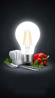 Glowing LED filament bulb with chef hat, fork, knife and red bell peppers on dark background representing culinary innovation and cooking creativity concept.