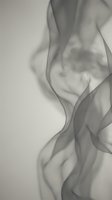 Flowing gray and white fabric with soft, billowing waves creates an elegant, minimalist composition suitable for backgrounds, design elements, and contemporary artistic projects.