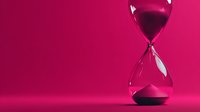 Pink hourglass with flowing sand on vibrant magenta background symbolizing time management and deadline concepts for business presentations.