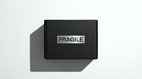 Black cardboard box with fragile label on white background, suitable for shipping, packaging, logistics, and delivery concepts.