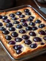 Freshly baked blueberry cake in rectangular baking pan with golden crust and plump berries, ready for dessert, bakery, or food photography use.