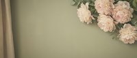 Soft pink peonies arranged on sage green background with vintage wooden frame edge creating elegant floral composition for wedding invitations.