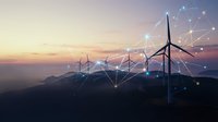 Wind turbines on mountain ridge at sunset with digital network connections overlay representing smart grid technology and renewable energy innovation.