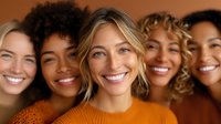 Diverse group of smiling women with different skin tones and hair types wearing autumn-colored sweaters against brown background, representing friendship and unity.