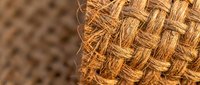 Natural jute rope texture with woven basket weave pattern showing organic fiber details for rustic craft and home decor projects.