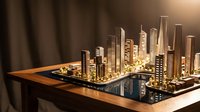 Architectural scale model of modern city skyline with illuminated golden buildings on wooden base and reflective surface, suitable for urban planning, real estate, and business presentations.