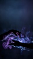 Two silhouetted hands with glowing purple and blue energy flowing between them against dark background. Suitable for mystical, spiritual, magic, supernatural, and healing concepts.