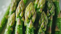 Fresh green asparagus spears with water droplets in macro view showing detailed texture and natural patterns. Organic vegetables for healthy eating concept.