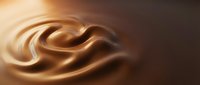 Smooth liquid chocolate swirls and waves in rich brown tones, creating an elegant abstract background for food, beverage, and luxury design projects.