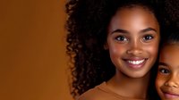 Young African American mother and daughter smiling together in warm portrait showing family bond and happiness for lifestyle photography.
