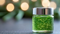 Luxurious green cosmetic gel with gold sparkles in glass jar on blurred bokeh background. Skincare and beauty product photography for spa and wellness.