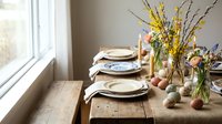 Easter table setting with spring flowers, colored eggs and natural decor on wooden dining table near window for holiday celebration.