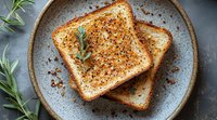 Crispy grilled cheese sandwich with black pepper and fresh rosemary garnish on rustic ceramic plate, overhead view showing golden brown toasted surface.